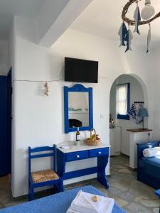 a room with a blue dresser and a bedroom at Cavos Studio by the sea in Drios
