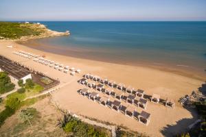 an overhead view of a beach with a bunch of umbrellas at Valtur Baia del Gusmay Beach Resort in Peschici