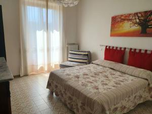 1 dormitorio con cama, ventana y silla en La Rosa appartamenti, en Monterchi