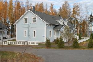 a white house with a black roof at SResort Apartment with 4 bedrooms in Imatra
