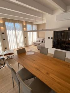 a dining room with a large wooden table and chairs at Suite Agli Archi in Torri del Benaco