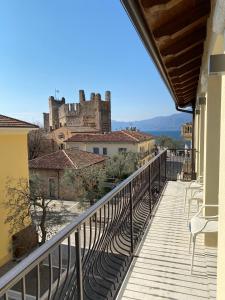 a balcony of a building with a castle in the background at Suite Agli Archi in Torri del Benaco