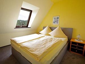 een slaapkamer met een groot bed en een raam bij Landhaus Sauerlandblick in Bestwig +21 foto's
