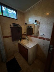 y baño con lavabo y espejo. en Villa Mola Mola en Candidasa