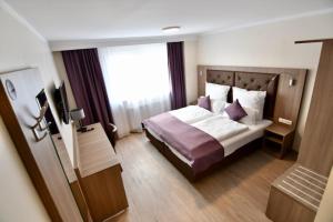 Rúm í herbergi á Ata Hotel - Self Check-in