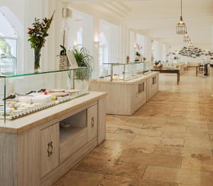 a store with a row of counters in a room at Falkensteiner Resort Capo Boi in Villasimius