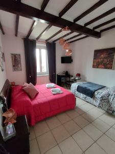 a bedroom with a large red bed in a room at B&B Pierilu' in Grosseto