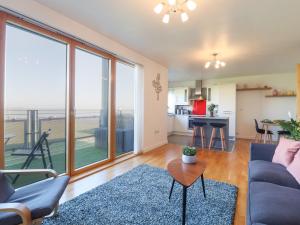 a living room with a couch and a table at Flat 19 By The Beach in Harwich