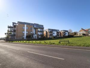 an empty road in front of some apartment buildings at Flat 19 By The Beach in Harwich