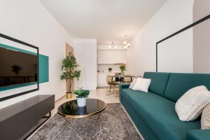 uma sala de estar com um sofá azul e uma mesa em Vagabond Grand'Or em Budapeste