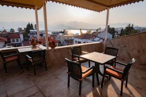 a patio area with chairs, tables and umbrellas at White Garden Hotel-Adult Only in Antalya