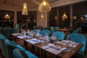 a dining room with tables and blue chairs at Resort Una Park in Bihać