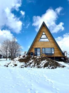 a house sitting on top of a pile of snow at A Marisel - 3 bedroom holiday home in Mărişel