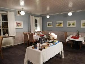 ein Esszimmer mit zwei Tischen mit Essen drauf in der Unterkunft Hotel Steinhagen in Damnatz