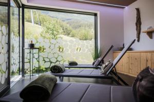 a room with a large window and a table at Chalet Ortles in San Valentino alla Muta