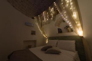 a bedroom with a bed with lights on it at Trullo Love in Alberobello