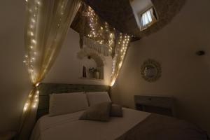 a bedroom with a bed with lights on it at Trullo Love in Alberobello