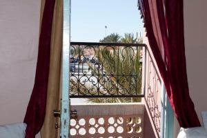 an open door to a balcony with a view at Hotel Bab Sahara in Ouarzazate
