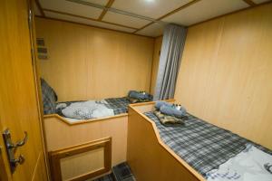 a small room with two beds in it at Nova Spero Boat & Breakfast - Caledonian Canal in Fort William