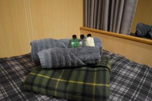 a bed with two bottles sitting on top of it at Nova Spero in Fort William