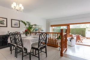 a dining room with a table and chairs at La marinera Beach House in Platja  d'Aro