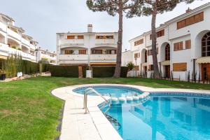 a swimming pool in the yard of a house at La marinera Beach House in Platja  d'Aro