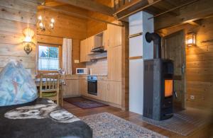 una sala de estar con estufa de leña en una cabaña en Ferienhaus Dummer en Flattach