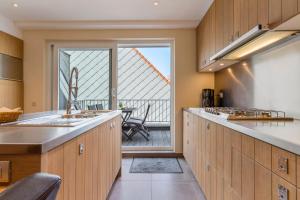 a kitchen with a view of a balcony at Duplex apartment with terrace - next to the beach in Knokke-Heist