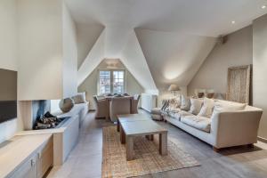 a living room with a couch and a fireplace at Duplex apartment with terrace - next to the beach in Knokke-Heist