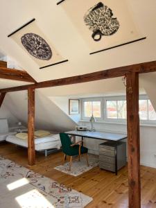 an attic bedroom with a desk and a bed at Westfälischer Hof - Loft 