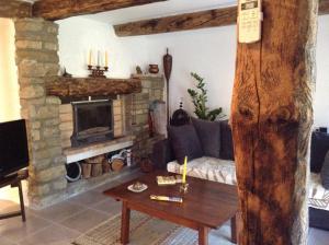 a living room with a couch and a fireplace at Très belle maison de campagne en pierre de grès in Braux