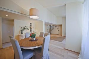 a dining room with a wooden table and chairs at Apartments Florence - Alfani in Florence