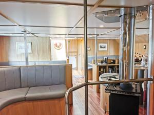 a living room with a couch in a boat at Nova Spero Boat & Breakfast - Caledonian Canal in Fort William