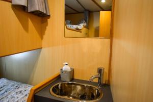 a bathroom with a sink and a mirror at Nova Spero Boat & Breakfast - Caledonian Canal in Fort William
