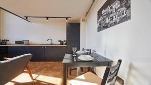 a dining room with a table and chairs and a kitchen at No 4 at Simpson Street Apartments Sunderland in Sunderland