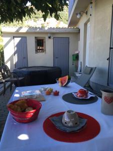 einen Tisch mit einem weißen Tischtuch mit Essen drauf in der Unterkunft Casa Basgiu, chambres avec balcon in Zilia