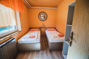 two beds in a small room with a window at Apartma Rombon Brdo with Free Onsite Parking in Bovec