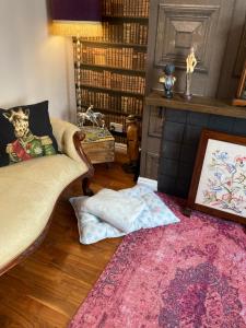 a living room with a couch and a pink rug at Bedford House Retreat in Scarborough