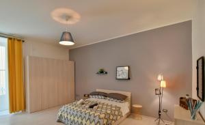 a bedroom with a bed and a large window at Tasso Apartment in Salerno +13 photos