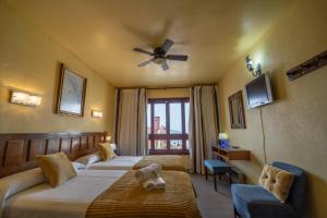a bedroom with a large bed and a large window at Hotel Apartamentos Londres La Manga in La Manga del Mar Menor