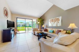 a living room with couches and a flat screen tv at Palm Springs Condo, Sunrise Villas in Palm Springs