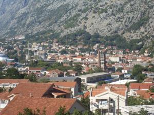 a large building with a view of the mountains at Guest House Sandra in Kotor