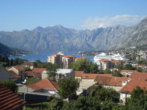 a small town with houses and a mountain range at Guest House Sandra in Kotor