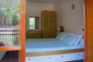 a bed in a room with a window at Beach House Blue Holiday in Letojanni