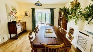 a dining room with a wooden table and chairs at Ritson Farm - Large Traditional Farm House in Totnes