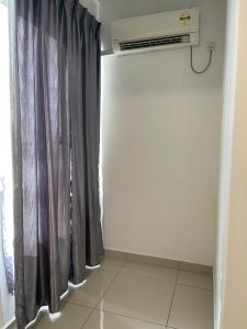 a room with a black curtain and a heater at Marina Heights Hotel Residency in Lumut