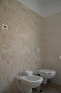a bathroom with a white toilet and a sink at Agriturismo La Ca' d'Amelio in Lessolo +19 photos