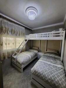 two bunk beds in a bedroom with a chandelier at Villa Overlooking Beach - Private Swimming Pool! in Tangier +20 photos
