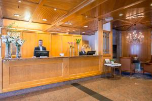 two men sitting at a reception desk in a lobby at Losby Gods Manor in Losby