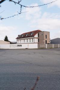 un edificio con un cartello sul lato di STEP INN The Fair Hotel a Rosbach vor der Höhe